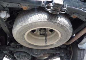 The spare wheel of a used 2009 Toyota Land Cruiser Prado from online used Japanese car dealer BE FORWARD.